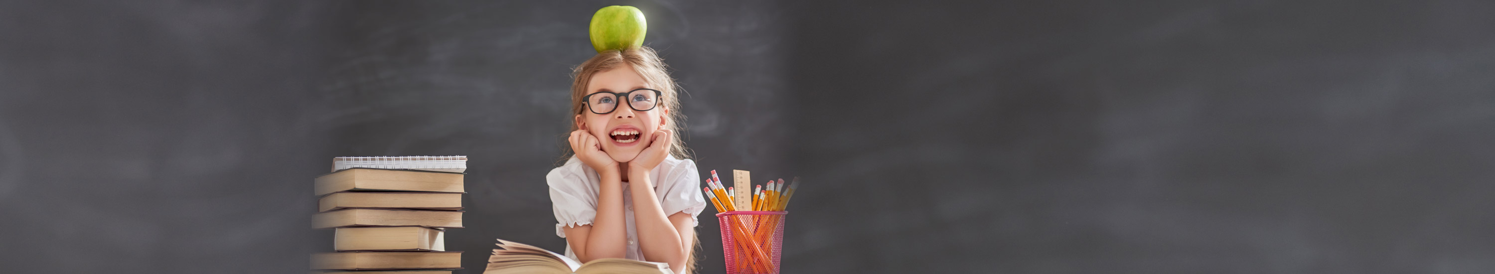 Young girl with apple on her head