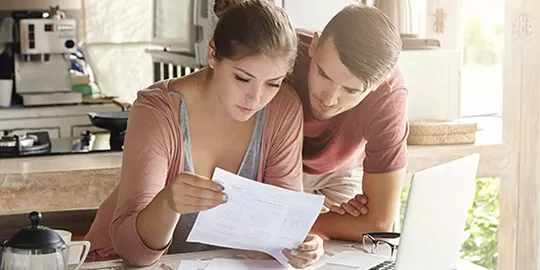 Couple at table looking over paperwork
