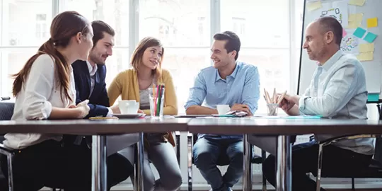 People around table talking